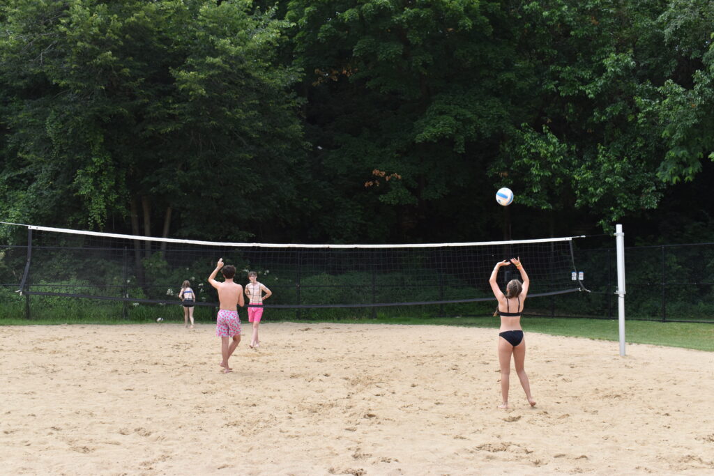Kids play sad volleyball outdoors