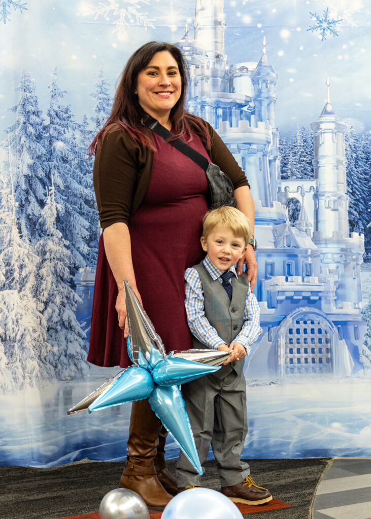 2 Ties and Tiaras attendees smiling for a picture.