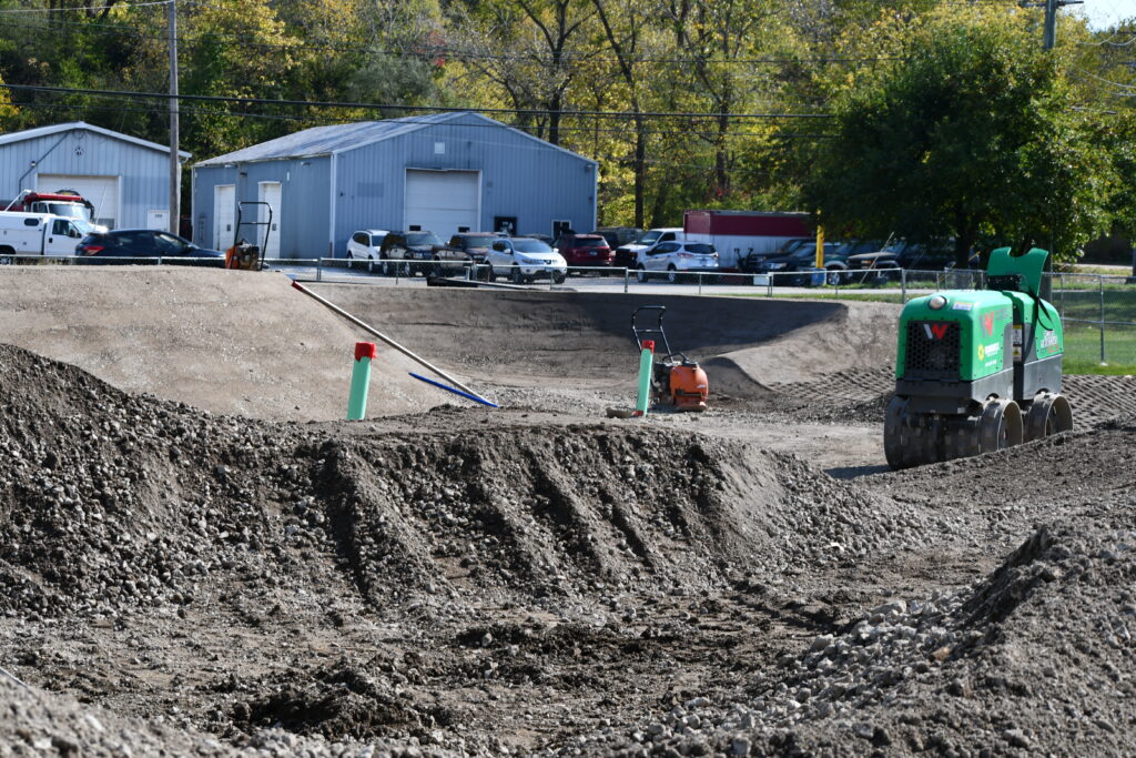 Construction at a district park showing piles of dirt
