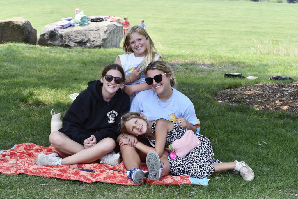 Two campers pose with two camp counselors