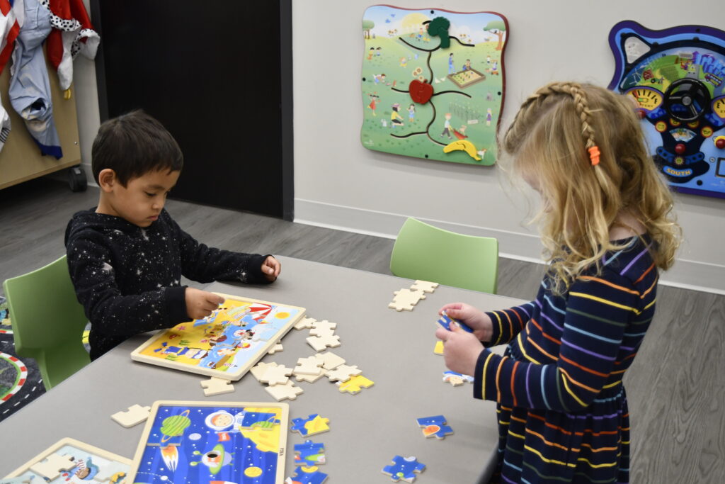 Two students work on puzzles