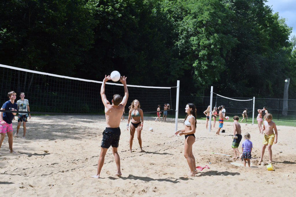 teens playing sand volleyball