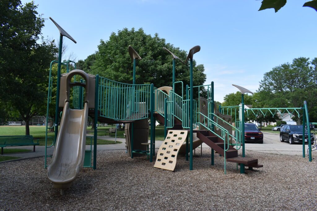 Braeburn Park and Preserve playground displaying a slide, climbing structure and monkey bars.