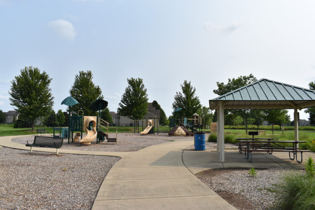 A path that goes beside the pavilion and playground.