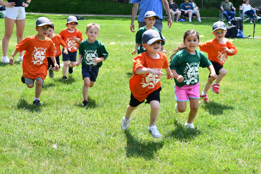 Young All Star Sports players run during a warmup exercise in the park
