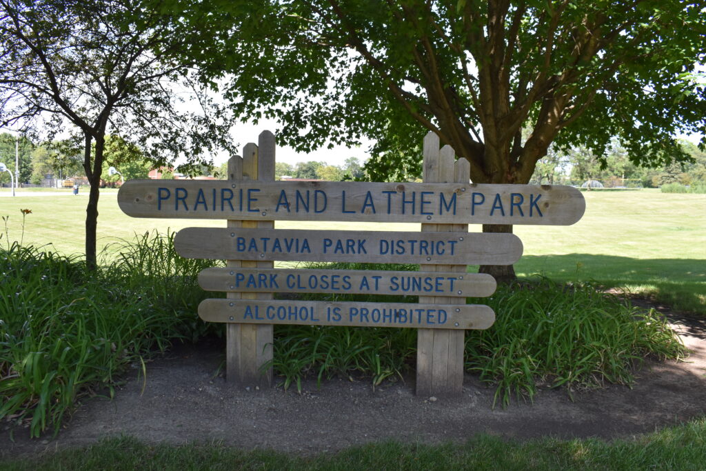 Prairie and Lathem Park sign stating park name and hours.