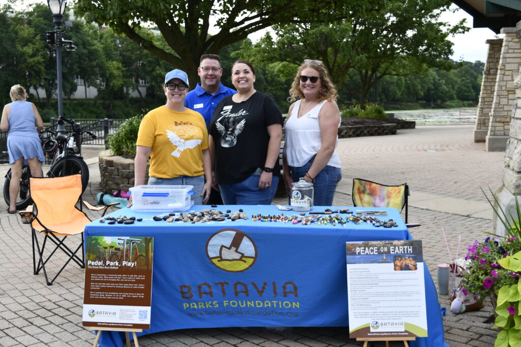 Batavia Parks Foundation members stand behind a branded table at an event