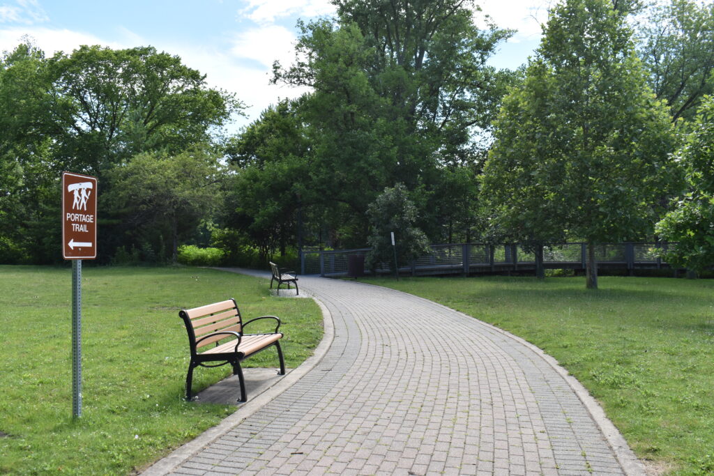 Batavia Riverwalk pathway with benches along the path.