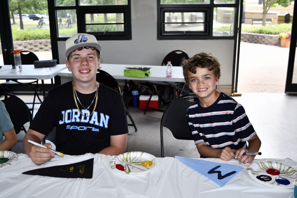 Two boy campers work on an art project during summer camp