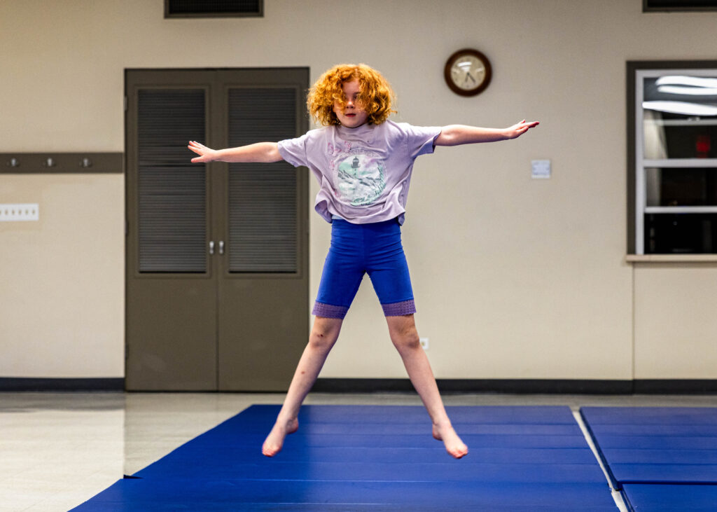 A tumbling student jumps in mid air