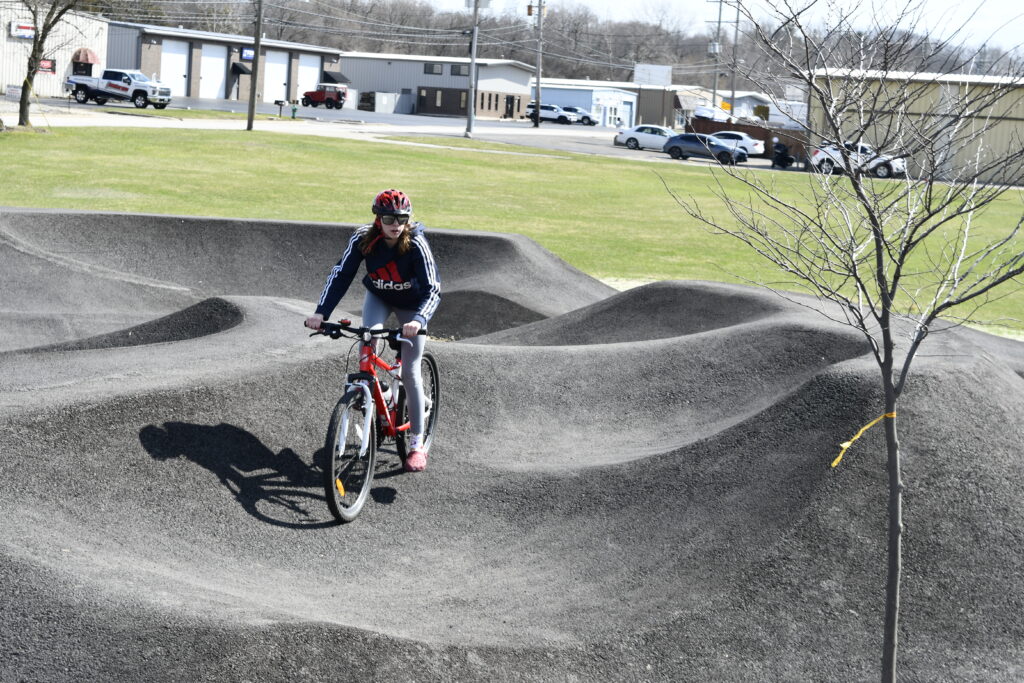 Clark Island Recreation Area showing a resident riding their bike at Blackard Skate-n-Bike Park.