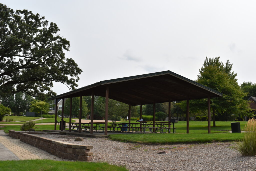 Hawks Bluff Park pavilion with picnic tables and trash cans.