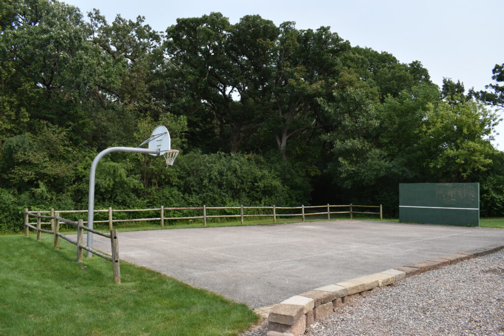 Hawks Bluff Park asphalt play court with a basketball hoop.