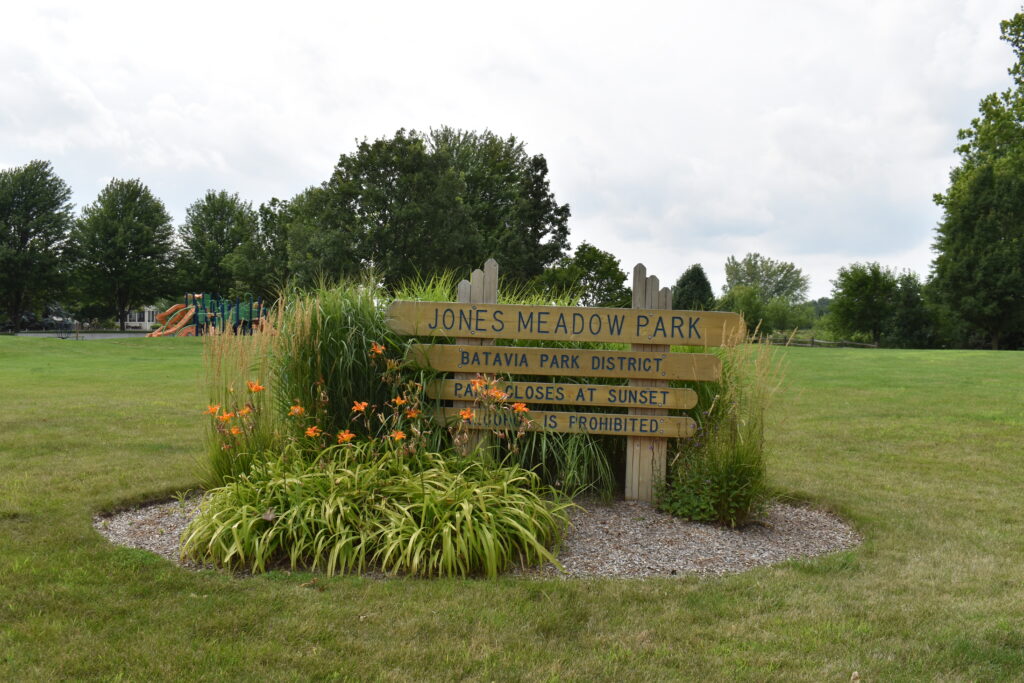 Jones Meadow Park sign showing park name and hours of park.