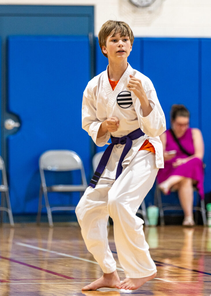 A karate student displays proper form in class