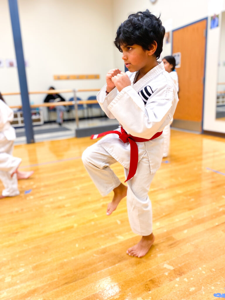 A karate student works on his form in class