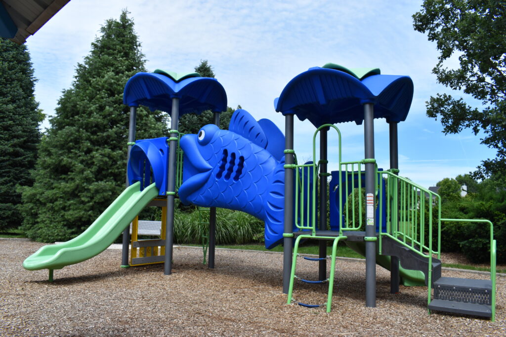 Levi Newton Park showing a playground geared towards younger children with a small slide and climbing equipment.