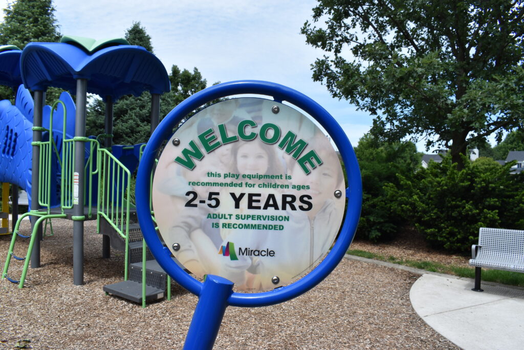 Levi Newton Park showing a welcome sign that shows the smaller play equipment is geared towards 2-5 year old children.