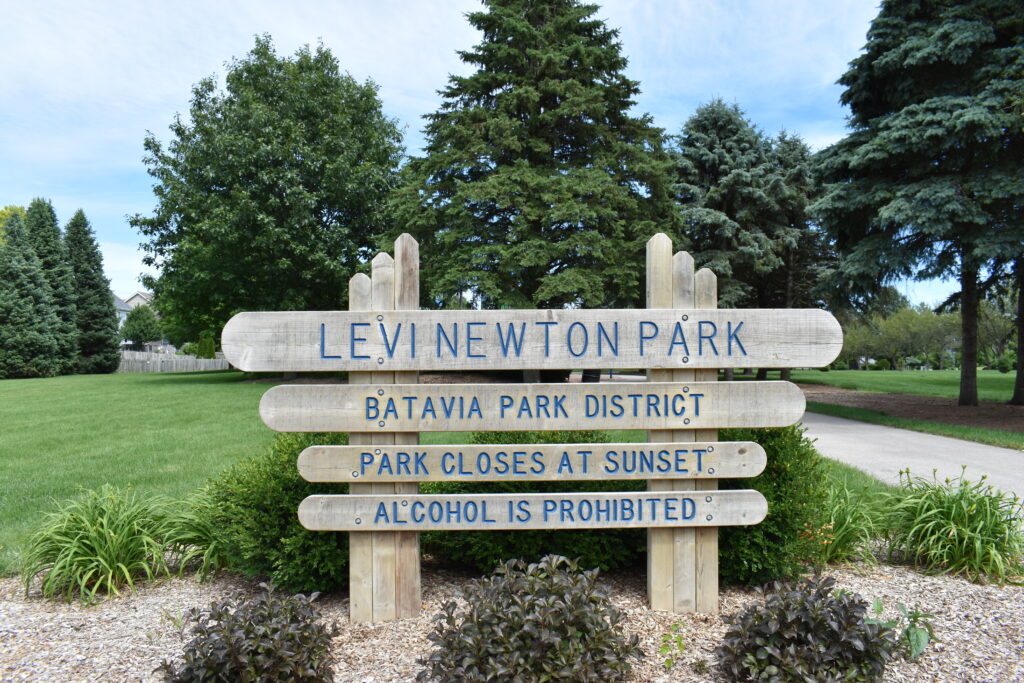 Levi Newton Park showing park entrance sign that states the name of the park and hours.