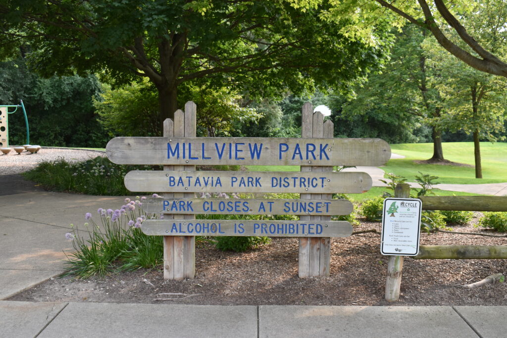 Millview Park sign with park name and hours.