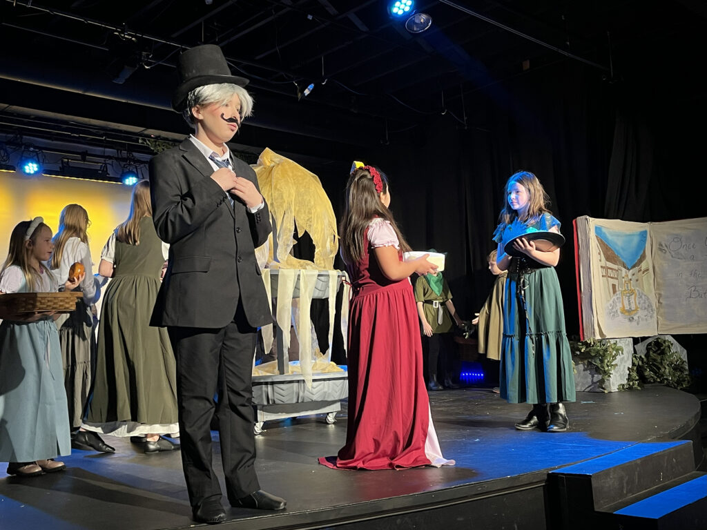 Child actors on stage performing a play