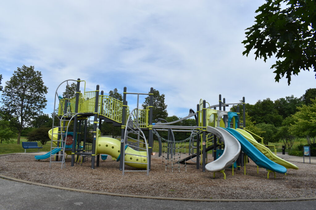 Prairie Path Park playground featuring multiple slides and climbing equipment.