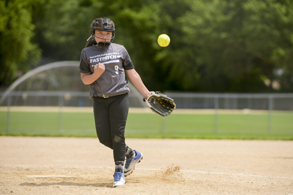 Softball player catching the ball during a game