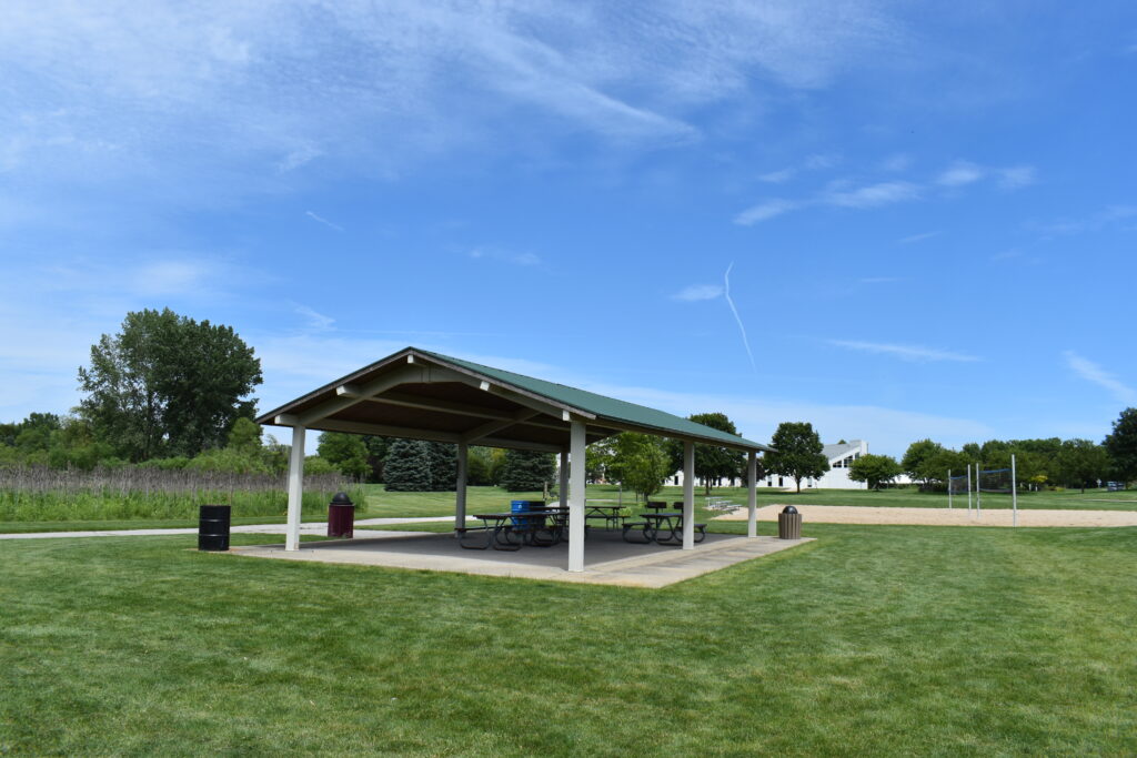 South Mill Creek Park rentable pavilion showing picnic tables and trash cans.