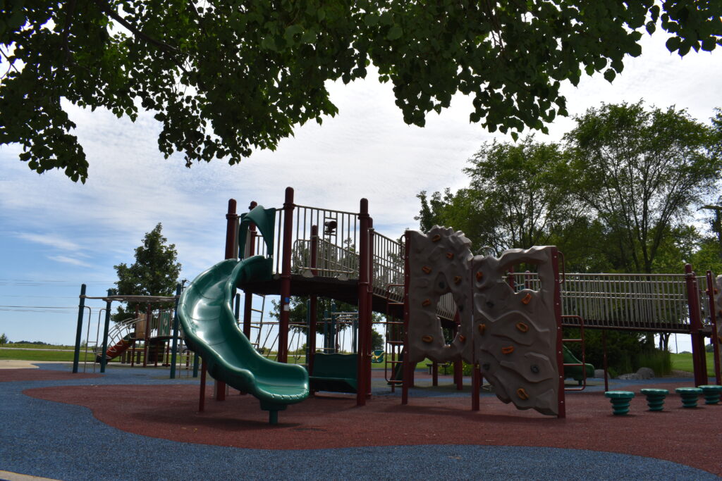 South Mill Creek Park playground showing a slide and climbing structure.