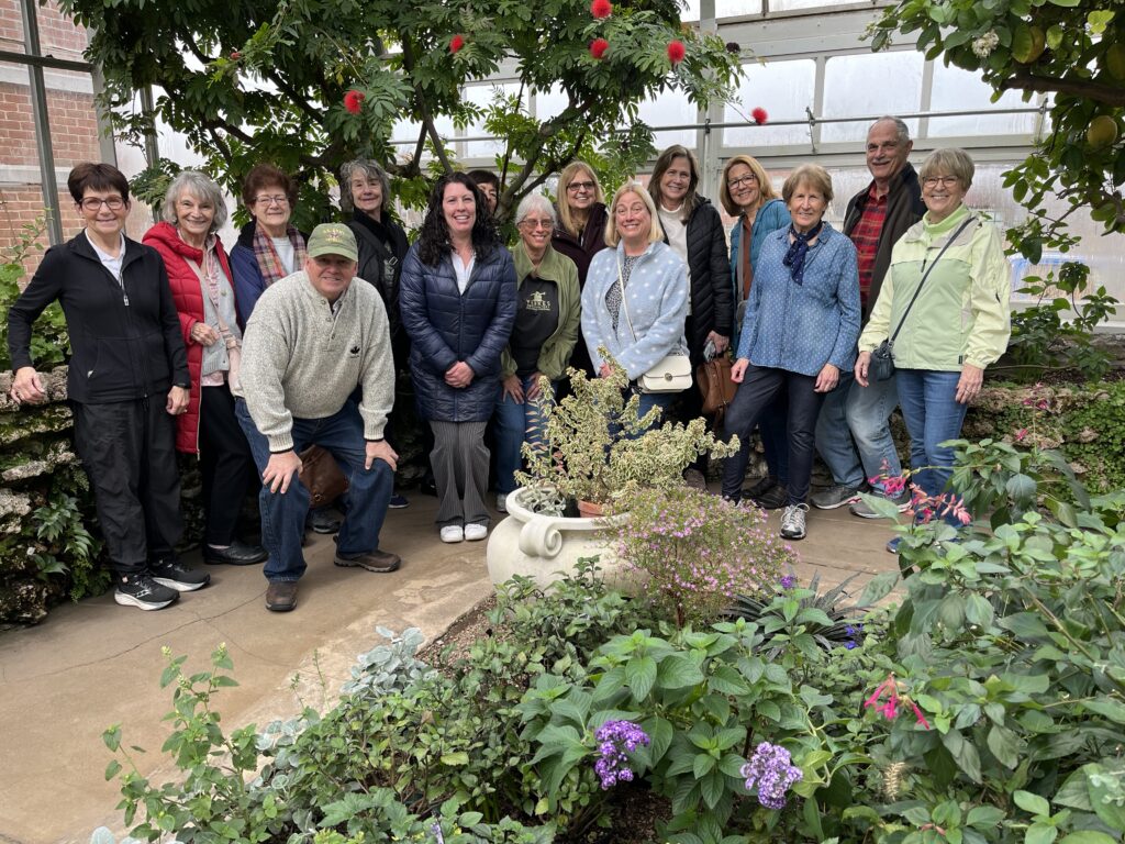Tour patrons pose for a photo during a greenhouse tour