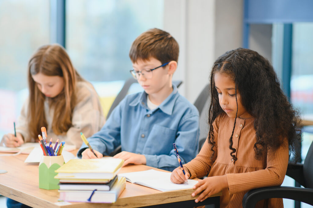 Three kids participate in a creative writing exercise
