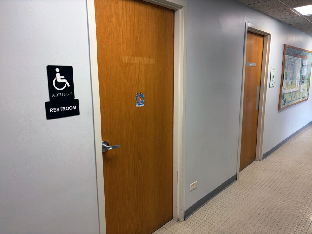 A hallway showing doors to two restrooms