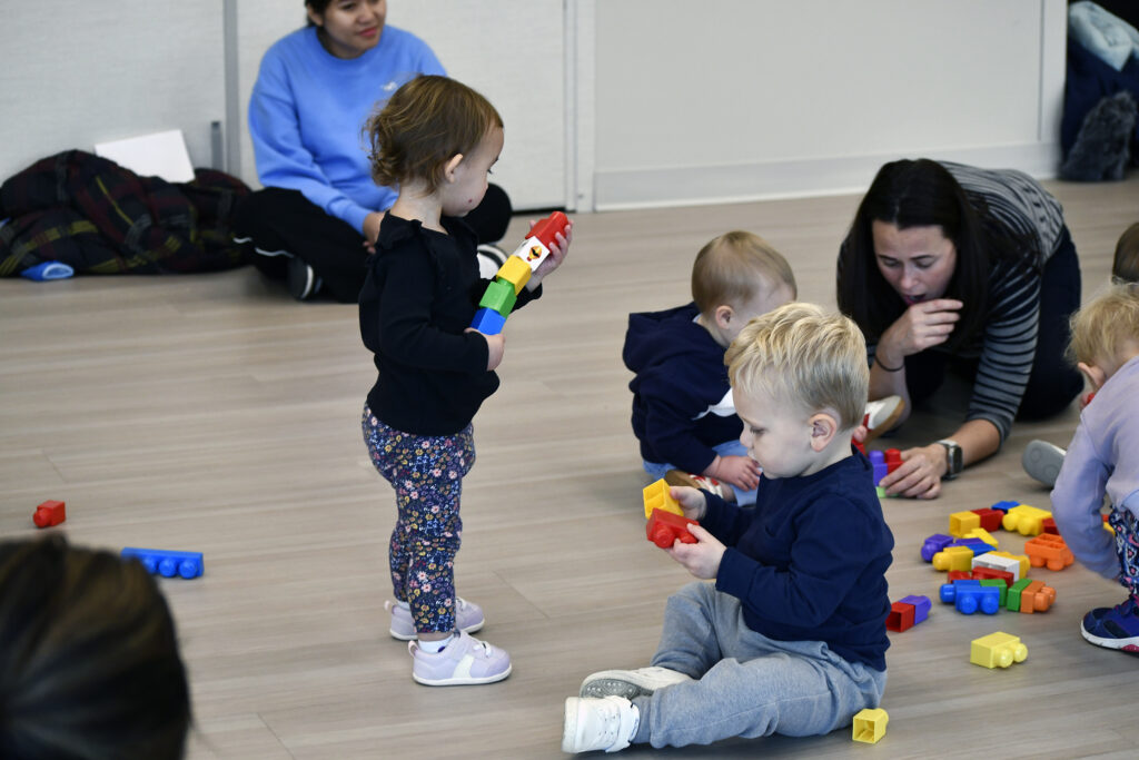 Toddlers play with blocks in a Tot Rock class.