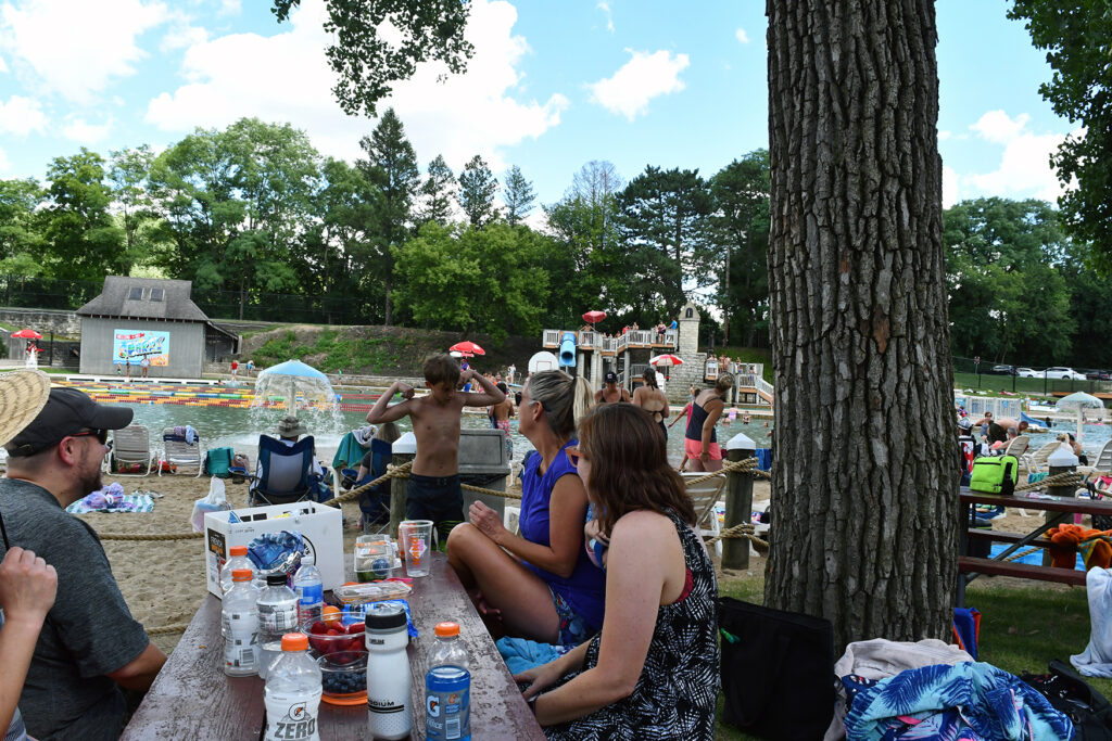 Families at a picnic area at an outdoor swim facility