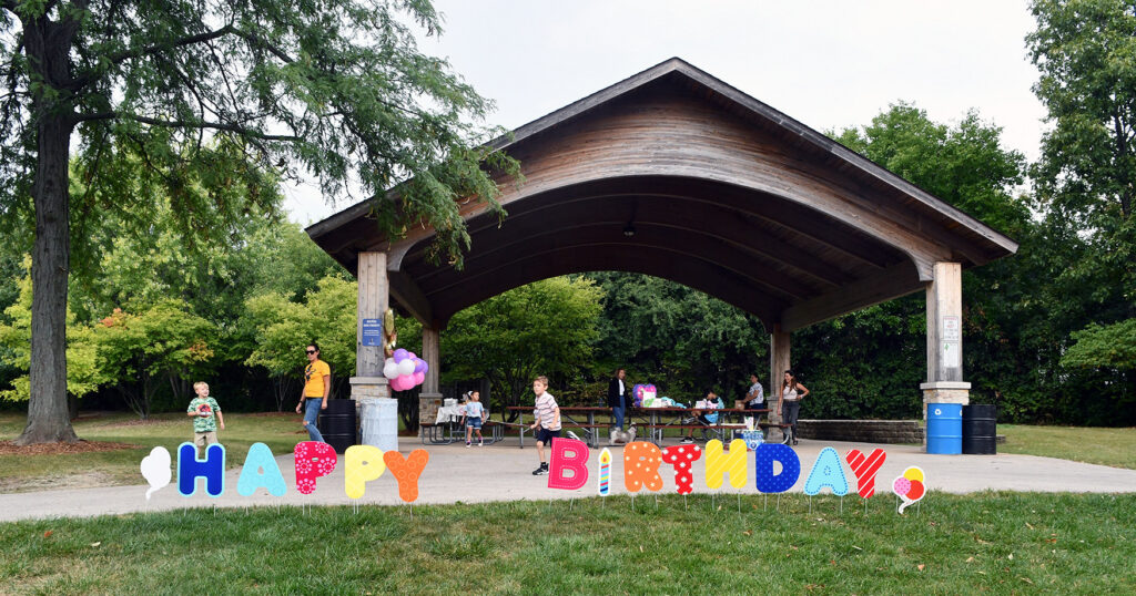 family birthday party at outdoor park pavilion